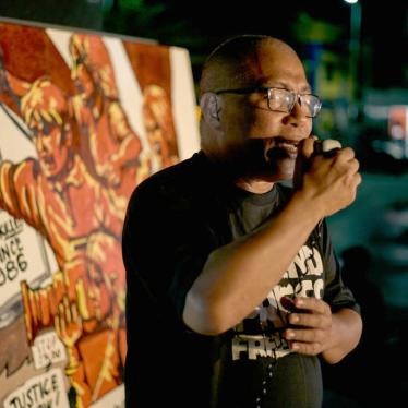 National Union of Journalists of the Philippines chairman Nonoy Espina speaks to other journalists and activists as they gather to hold a vigil on the eve of the promulgation of the Maguindanao massacre trial on December 18, 2019 in Manila, Philippines.