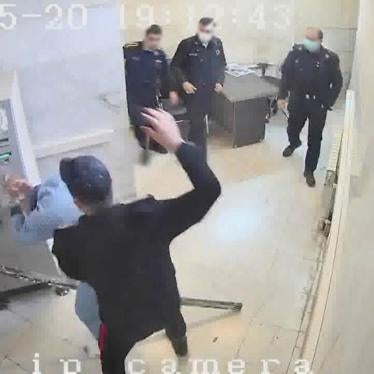 In this undated frame grab taken from video shared with The Associated Press by a self-identified hacker group called "The Justice of Ali," a guard hits a prisoner, at Evin prison in Tehran, Iran. 