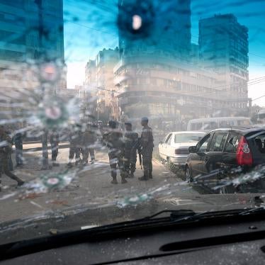 Lebanese army soldiers are seen through the bullet-riddled window of a car after deadly clashes erupted in Beirut, Lebanon, Thursday, Oct. 14, 2021.