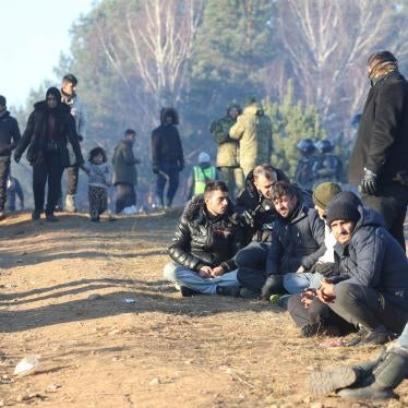 A group of men seated on the ground 