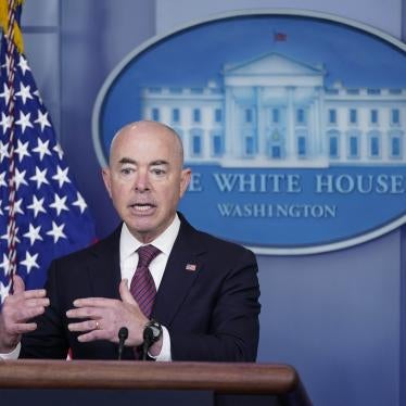 A man stands in front of a podium with the White House emblem behind him
