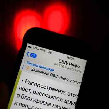An iPhone screen shows the Telegram account of OVD-Info