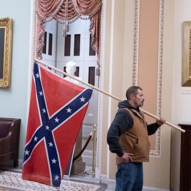 A protester stands with a Confederate flag after storming the Capitol during a Joint Session of Congress in which members were to certify the 2020 Presidential election on January 6, 2021.
