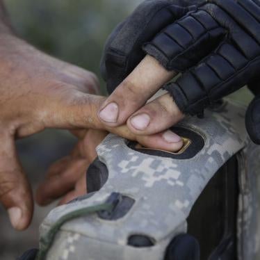 A United States military official takes the fingerprints of a man in Afghanistan