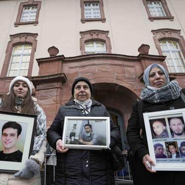 3 women hold framed photographs