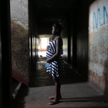 A 16-year-old girl who is pregnant stands in the hallway of her residence in Mbare township in Harare, Zimbabwe, November 2021.