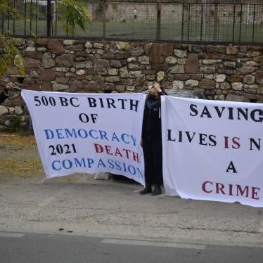 People hold banners outside a court