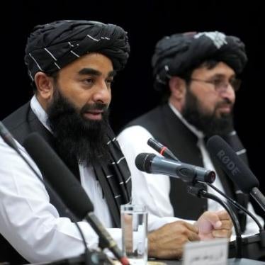 Zabiullah Mujahid, left, the spokesman for the Taliban government, speaks during a press conference