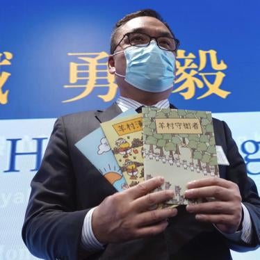 Li Kwai-wah, senior superintendent of Police National Security Department, poses with the children's book series Sheep Village at a press conference in Hong Kong, July 22, 2021.