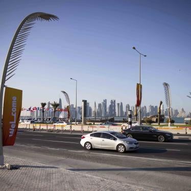 Evening traffic on the Corniche promenade with the skyline of West Bay Doha the background 