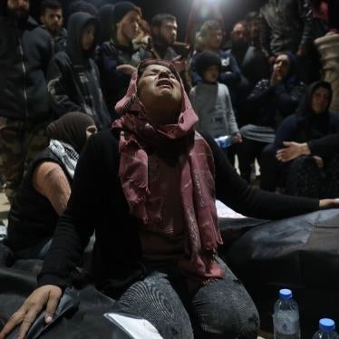 Relatives of the victims and the people of Jinderis gather in Atma city near the Syrian border with Turkey during funeral proceedings for the victims who died at the hands of Turkish-backed fighters during Newroz celebrations. 