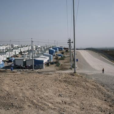 A boy walks on a road at the Mamrashan camp for civilians displaced by war, located a half hour's drive from Dohuk city in Iraq.