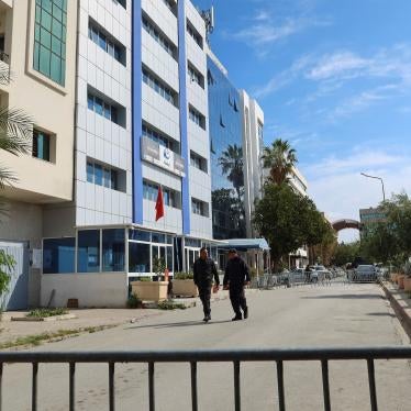 Police members walk outside the building of the Ennahda party headquarters, after police raided the headquarters and evacuated all present, Tunis, Tunisia.
