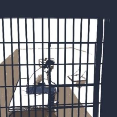 A man sits in a jail cell