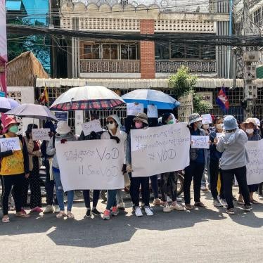 Supporters of online media outlet Voice of Democracy (VOD) hold placards in front of VOD office in Phnom Penh on February 13, 2023.