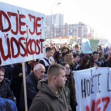 A man holds a banner that reads "Where is Humanity" during a protest following the release of disturbing photos from the Pazaric care home, Sarajevo, Bosnia, November 22, 2019. 