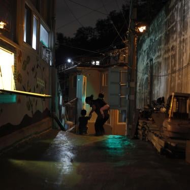 A “baby box,” where mothers can leave unwanted children, is visible on the left at Joosarang church as a preacher and two children go for a walk in Seoul, South Korea, September 20, 2012.