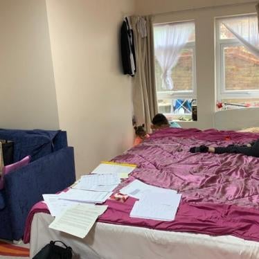 A mother watches her two children in a hotel room 