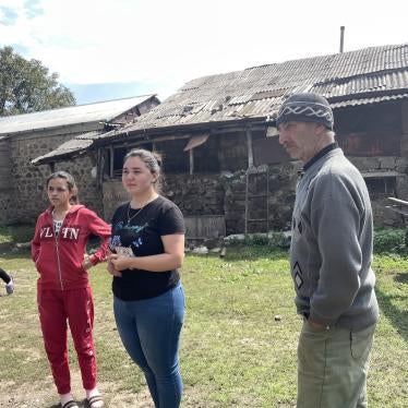 Ariana, 11, Amanda, 18, Agnessa, 22 with their grandfather Roma in front of a shed in Tatev, Armenia, the day after their long journey from Nagorno-Karabakh, September 29, 2023.