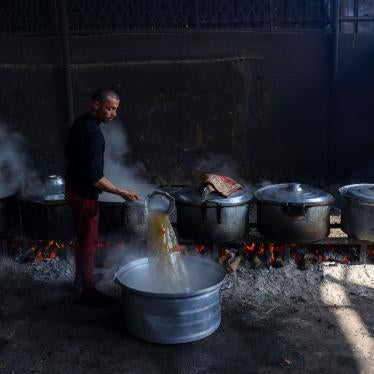 Palestinians prepare meals at a UN shelter to be distributed to displaced people in Rafah, in the southern Gaza Strip, October 23, 2023.