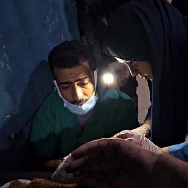 Medical workers treat a Palestinian injured in an Israeli strike, using flashlights due to the lack of electricity at the Indonesian Hospital in the northern Gaza Strip, November 10, 2023.