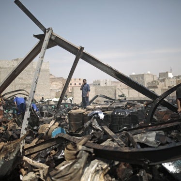 Workers salvage oil canisters from the wreckage of a store hit by Saudi-led airstrikes in Sanaa, Yemen, July 2, 2020.
