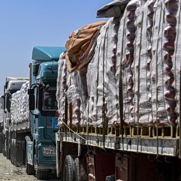  Egyptian trucks carrying humanitarian aid bound for the Gaza Strip queue outside the Rafah border crossing on the Egyptian side on March 23, 2024. 