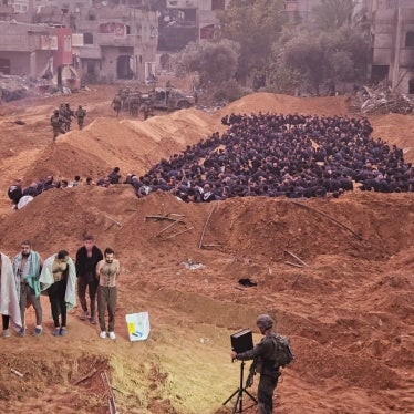 Dr. Khalid Hamoudeh (far left in the front) and Dr. Wadee Qasem (far right in the front) are detained along with other healthcare workers, internally displaced civilians, and patient’s families near the Kamal Adwan Hospital in northern Gaza.