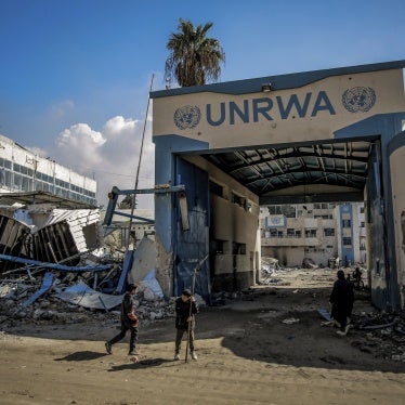 Palestinians examine damage to the United Nations Relief and Works Agency for Palestine Refugees (UNRWA) buildings