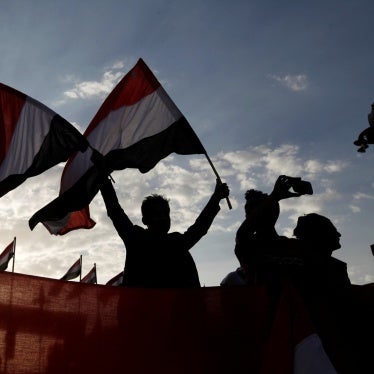 A person waves Yemeni flags during a ceremony marking the anniversary of the September 1962 revolution in Sanaa, Yemen.