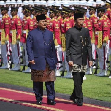 Indonesia's newly inaugurated president, Prabowo Subianto, left, and his predecessor, Joko Widodo, inspect honor guards during their handover ceremony at Merdeka Palace in Jakarta, Indonesia, October 20, 2024.