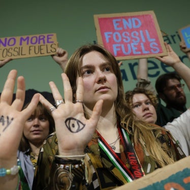 Activists with painted hands protest against fossil fuels and for climate finance at the COP29 Climate Conference in Baku, Azerbaijan, November 22, 2024.