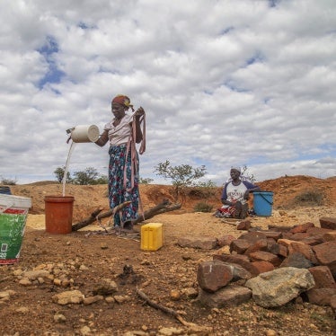 Villagers fetch water from a makeshift borehole during a drought in Mudzi, Zimbabwe, July 2, 2024.