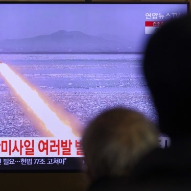 A TV shows a missile launch.