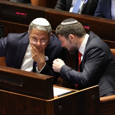 Former Israeli Knesset member and current National Security Minister Itamar Ben Gvir (R) and Minister of Finance Bezalel Smotrich speak in parliament, in Jerusalem, November 15, 2022.