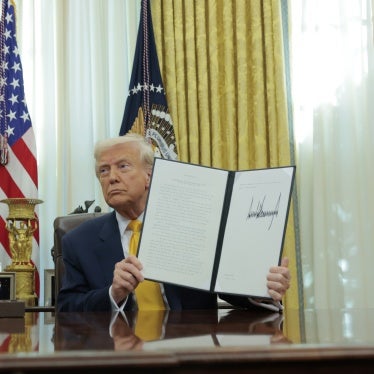 US President Donald Trump holds up an executive order alongside President of Fédération Internationale de Football Association (FIFA) Gianni Infantino in the Oval Office at the White House in Washington, DC,  March 7, 2025.