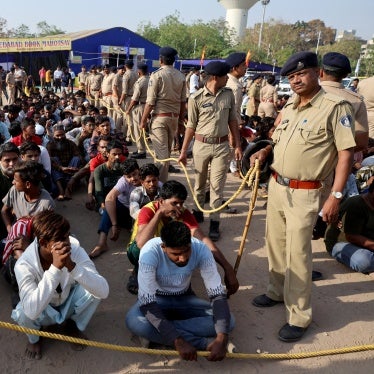 Police officers detain alleged undocumented Bangladeshi nationals after they were arrested during raids in Ahmedabad, India, April 26, 2025.