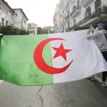 Demonstrators carry an Algerian flag in Algiers, Algeria, April 2, 2021.