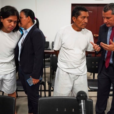 Alejandro Henríquez, left, and José Ángel Pérez, right, speak with their lawyers before their first court hearing in Santa Tecla, El Salvador, May 30, 2025.