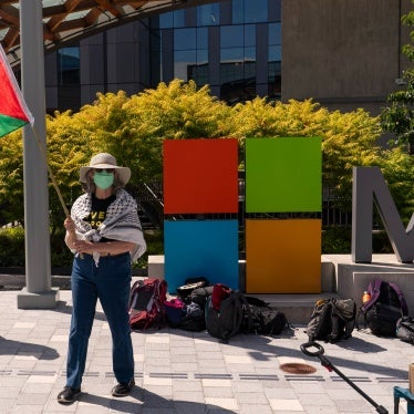 A demonstrator holds a Palestinian flag during a protest at the Microsoft Campus in Redmond, Washington, US, August 19, 2025.