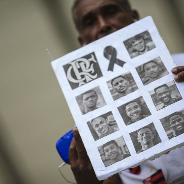 A fan shows photos of athletes of died