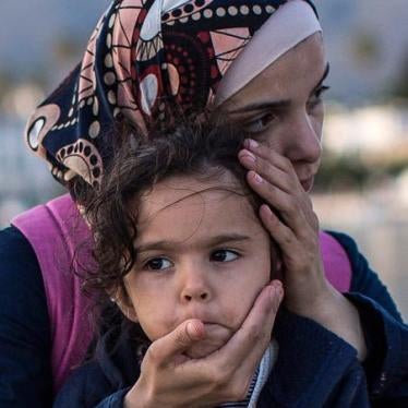 A Syrian woman embraces her daughter on the dock side after being escorted into the harbor by the Greek Coastguard who found them drifting offshore on June 4, 2015 in Kos, Greece.