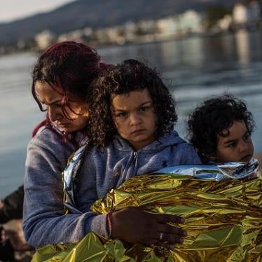 A Syrian family sit on the dock side after being escorted into the harbor by the Greek Coastguard who found them drifting offshore on June 4, 2015 in Kos, Greece. 