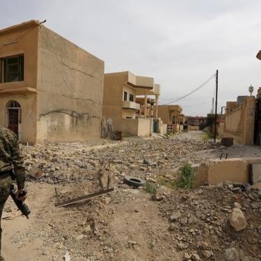 Pro-government fighter walking in a rubble-strewn street in Tikrit, Iraq on April 1, 2015, after the city had been recaptured from ISIS.