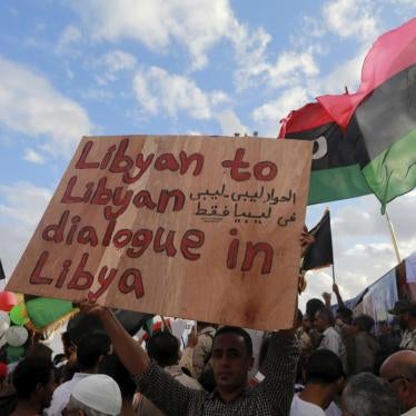 A man holds a sign during a protest against candidates for a national unity government proposed by U.N. envoy for Libya Bernardino Leon, in Benghazi, Libya October 23.