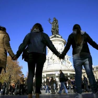 People hold hands to form a human solidarity chain near the site of the attack at the Bataclan concert hall in Paris
