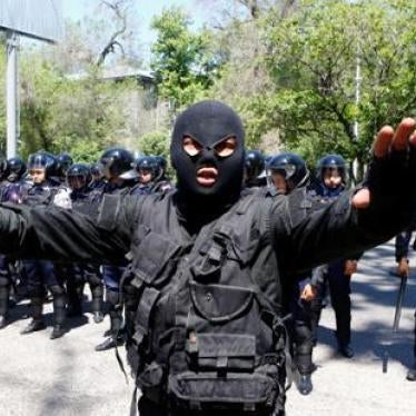 Riot police officer gestures during protests in Almaty, Kazakhstan on May 21, 2016.