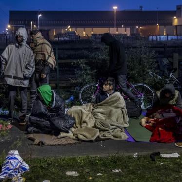 A group of boys from the Calais migrant camp tries to stay warm where they are sleeping overnight in the hope that registration of unaccompanied children and adults would resume in the morning, October 26, 2016. 