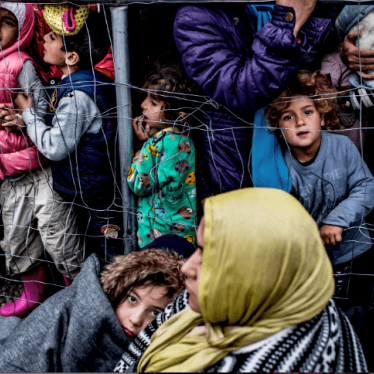 Families waiting for a bottle of water and a sandwich per person at a camp in Idomeni, Greece, March 2016.