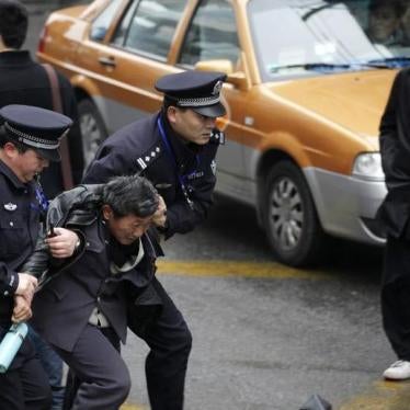 Police arrest a man in downtown Shanghai, after calls for a "Jasmine Revolution" protest on February 27, 2011.